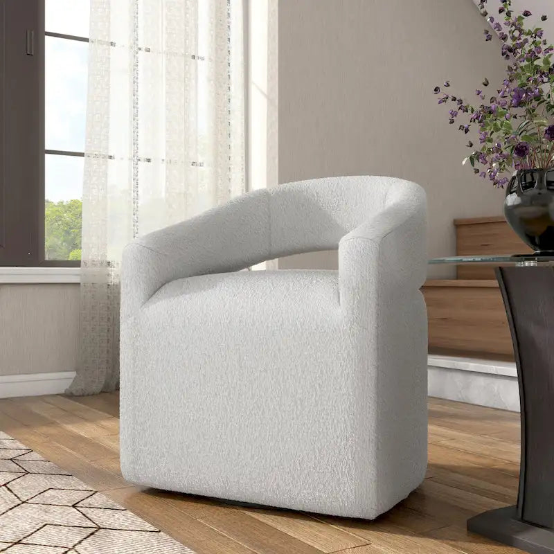 Fauteuil moderne de forme cylindrique avec dossier ajouré et accoudoirs incurvés ; fauteuil pivotant.