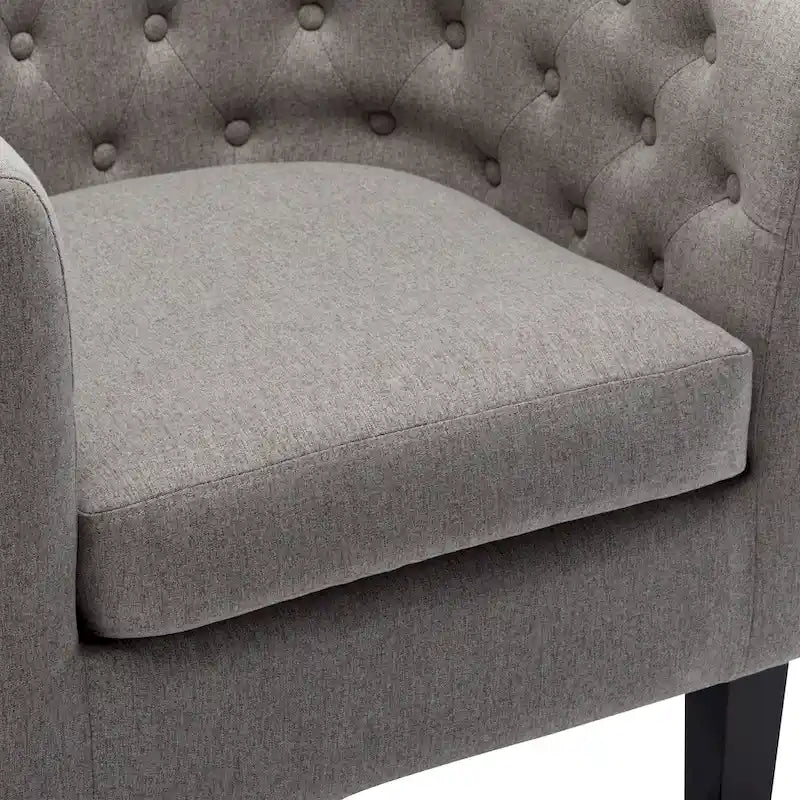 Fauteuil club capitonné en tissu